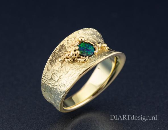 gouden ring met opaal en een natuurlijke structuur